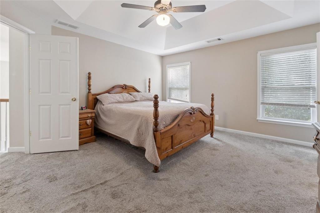 2747 High Creek Run Dacula, GA 30019 - Photo 30 of 48 a spacious bedroom with a bed and window