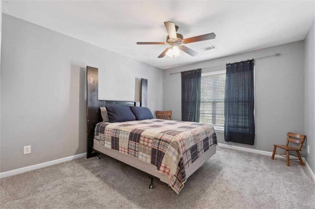 2747 High Creek Run Dacula, GA 30019 - Photo 42 of 48 a bed room with a bed and a ceiling fan