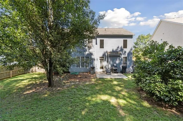 a view of a house with backyard and sitting area