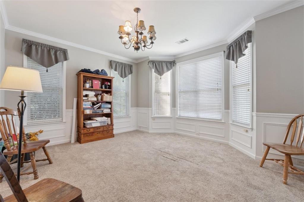 2747 High Creek Run Dacula, GA 30019 - Photo 10 of 48 a view of a livingroom with a cabinet and a chandelier
