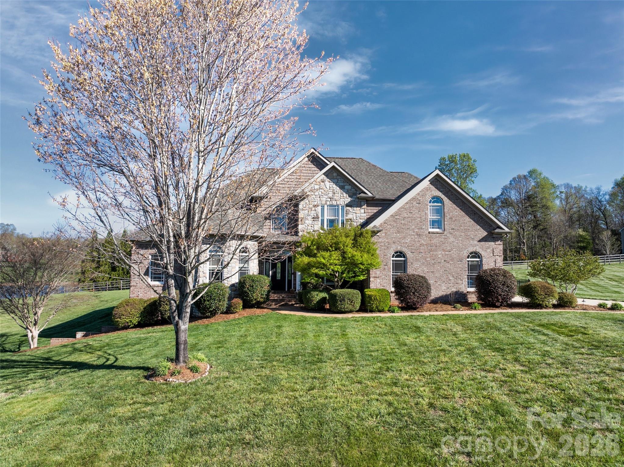 a front view of house with yard and green space