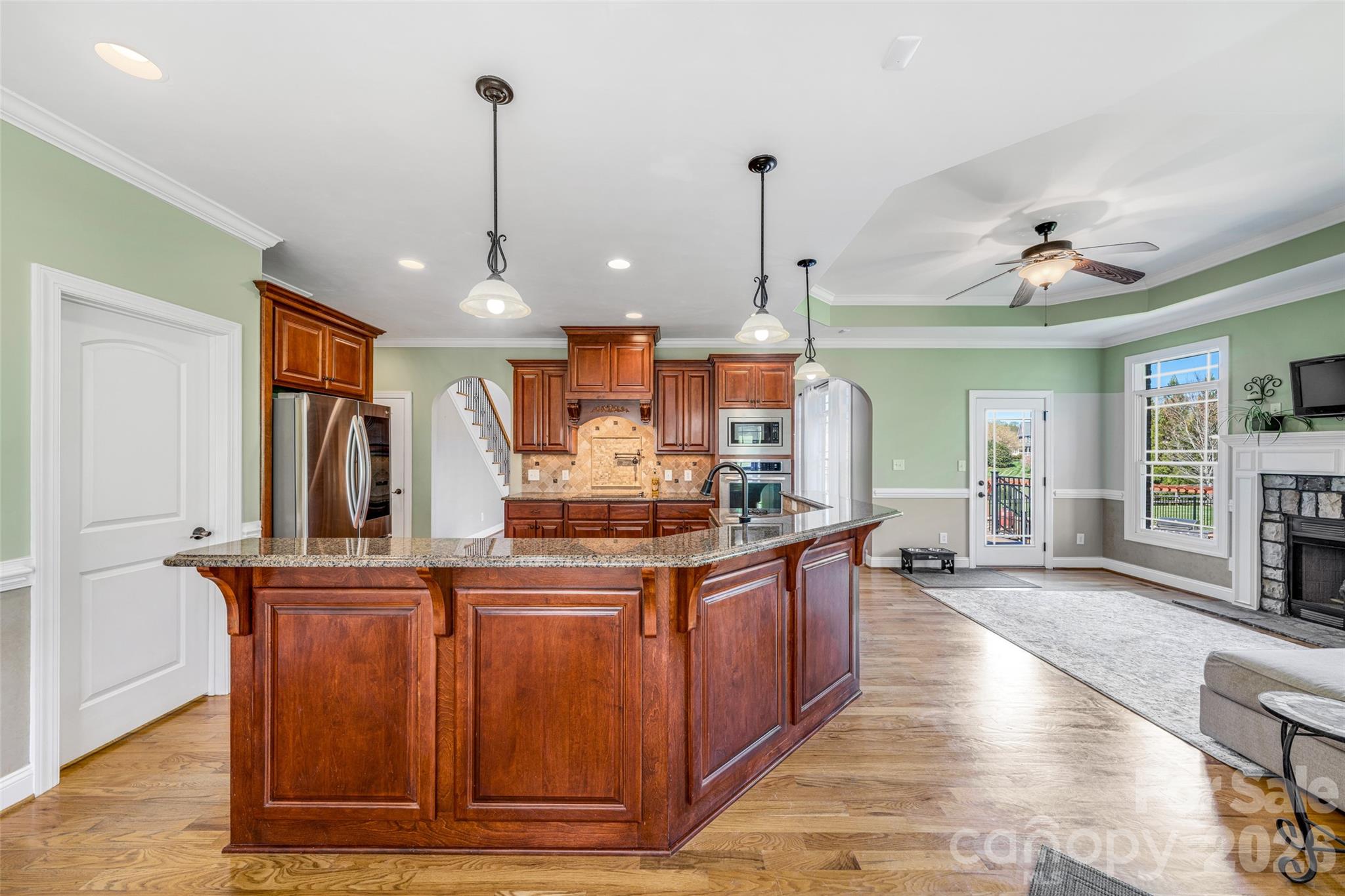 5873 Bakers Point Hickory, NC 28602 - Photo 11 of 48 a kitchen with stainless steel appliances granite countertop a sink a stove and a wooden floors