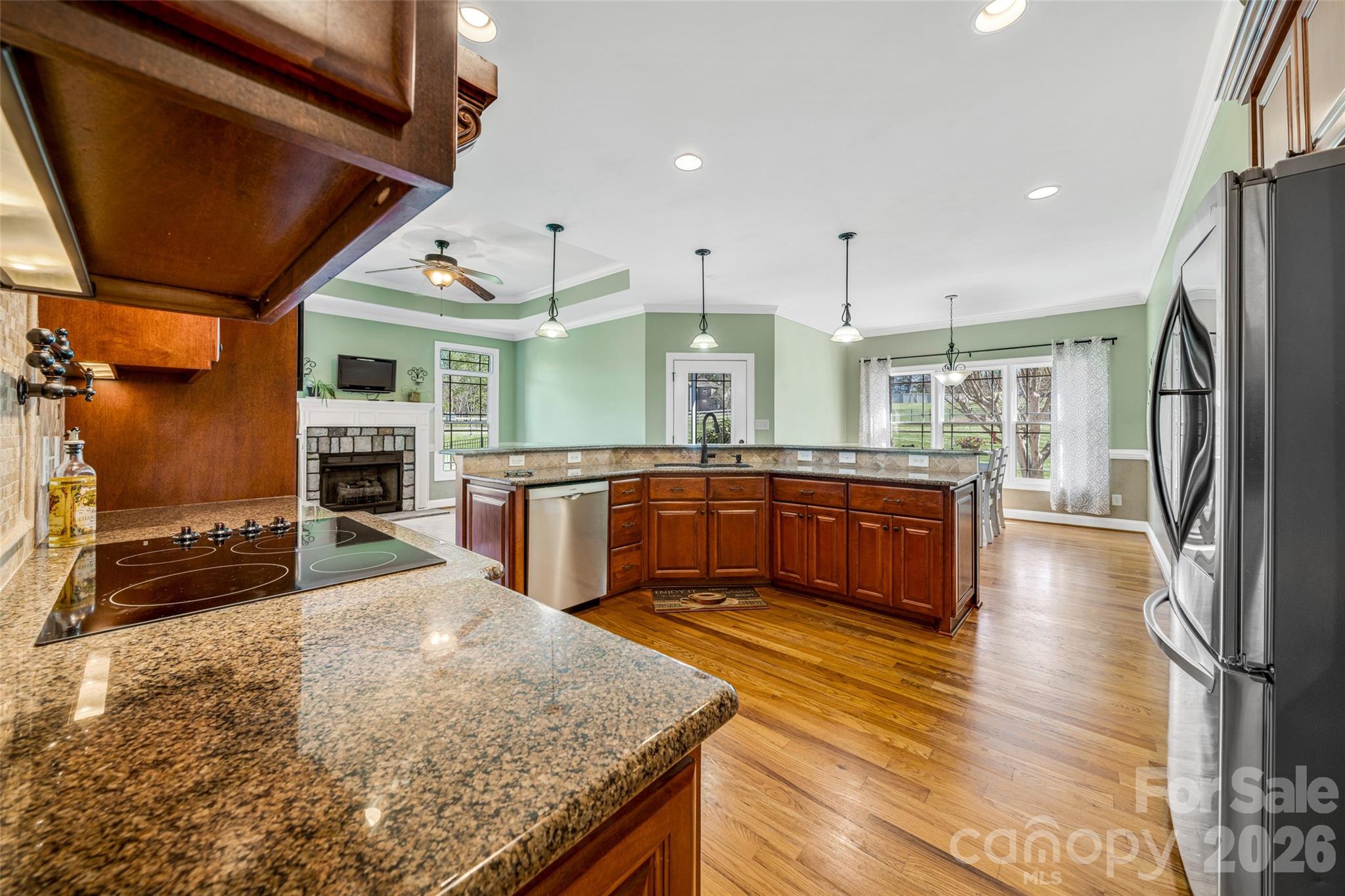 5873 Bakers Point Hickory, NC 28602 - Photo 8 of 48 a kitchen with stainless steel appliances granite countertop a sink a stove and a wooden floors