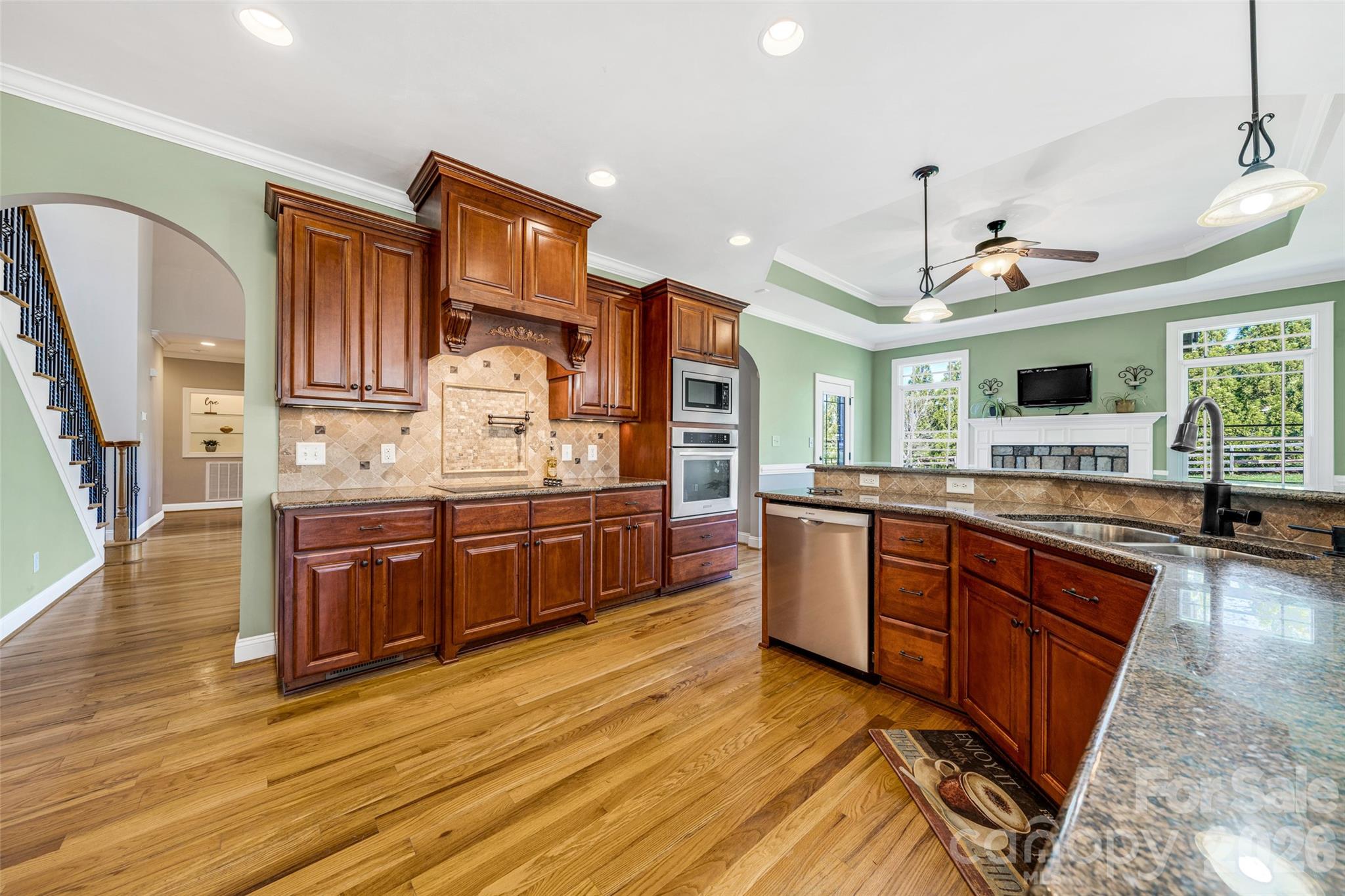 5873 Bakers Point Hickory, NC 28602 - Photo 9 of 48 a kitchen with stainless steel appliances granite countertop wooden cabinets a refrigerator and a stove