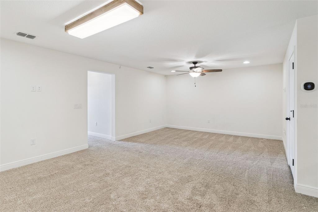 9009 Palm Key Avenue Oldsmar, FL 34677 - Photo 22 of 43 a view of a livingroom with a ceiling fan and window