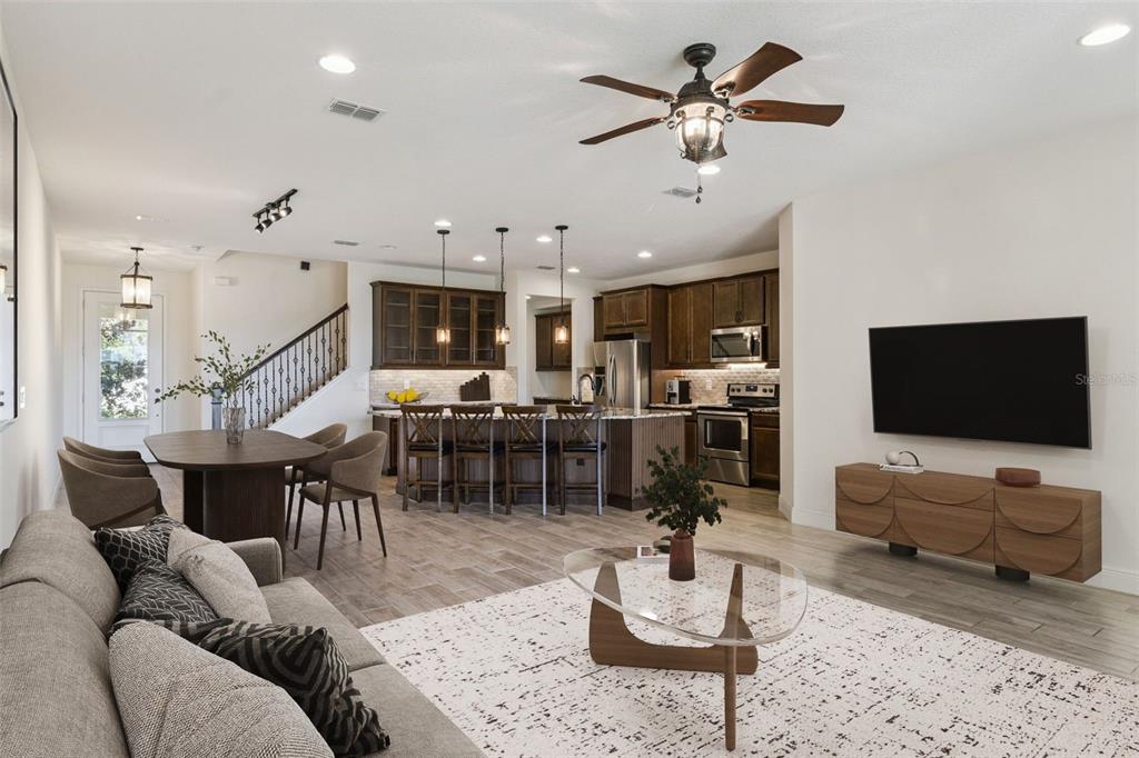 9009 Palm Key Avenue Oldsmar, FL 34677 - Photo 4 of 43 a living room with furniture kitchen view and a flat screen tv