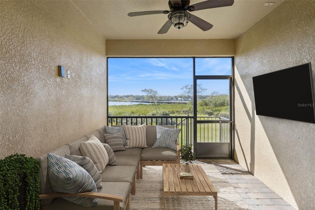 9009 Palm Key Avenue Oldsmar, FL 34677 - Photo 8 of 43 a living room with furniture and a flat screen tv