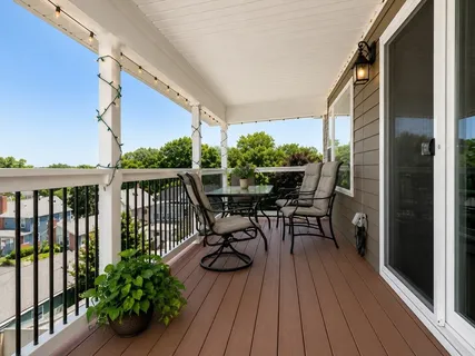 a view of balcony with chairs and wooden floor