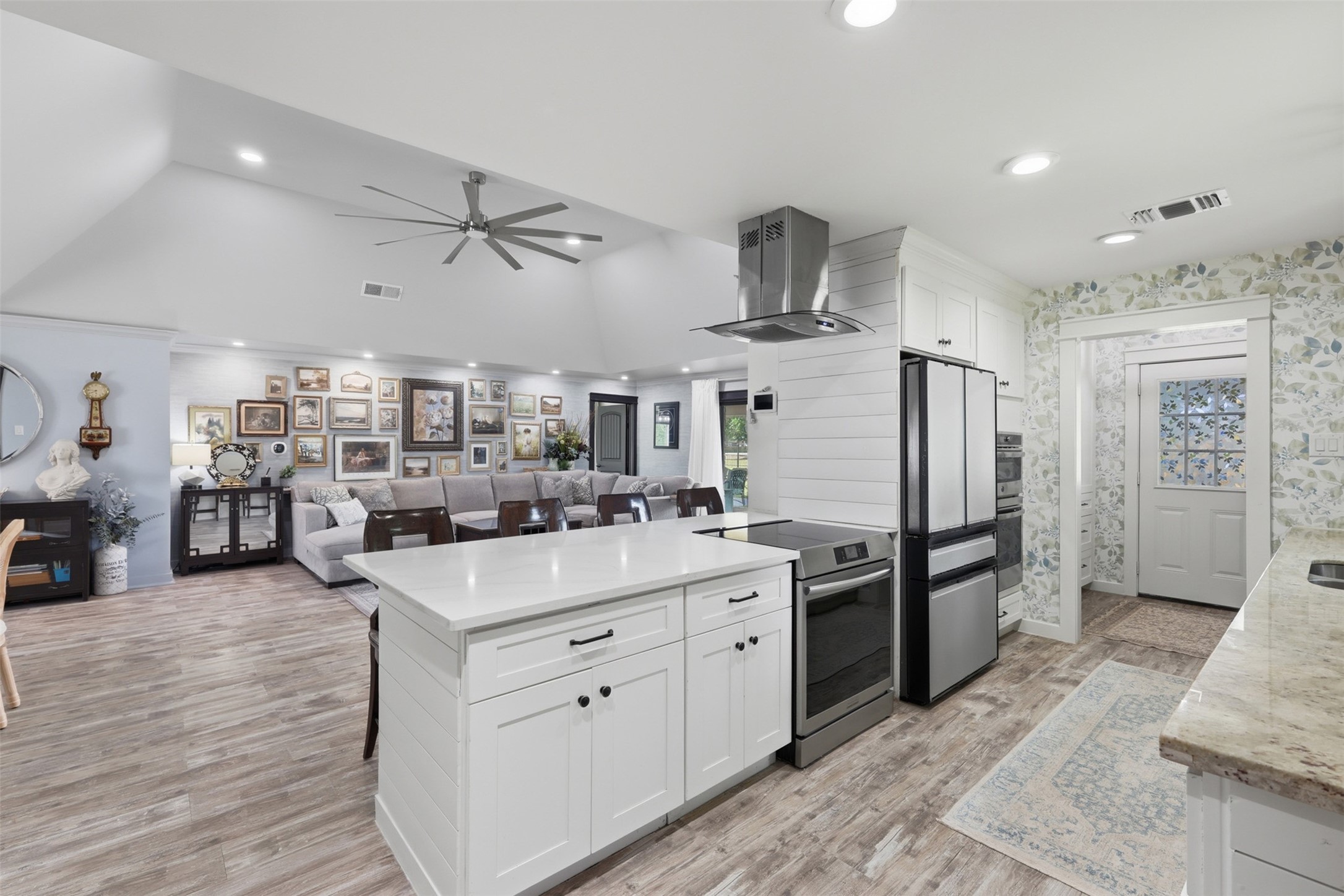 5111 Brookside Road Pearland, TX 77581 - Photo 14 of 42 Open concept living with vaulted ceilings, designer finishes, custom built ins, and seamless flow into the kitchen and outdoor living spaces.