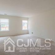41 Rainford Road Edison, NJ 08820 - Photo 16 of 19 a view of wooden floor and windows in a room