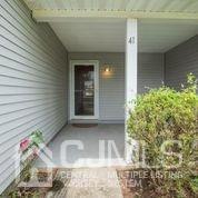 41 Rainford Road Edison, NJ 08820 - Photo 5 of 19 a view of yellow house with potted plants in front of door
