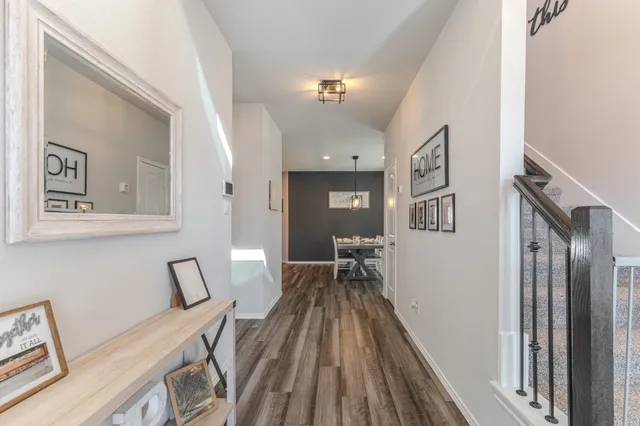 a view of a hallway with workspace and wooden floor