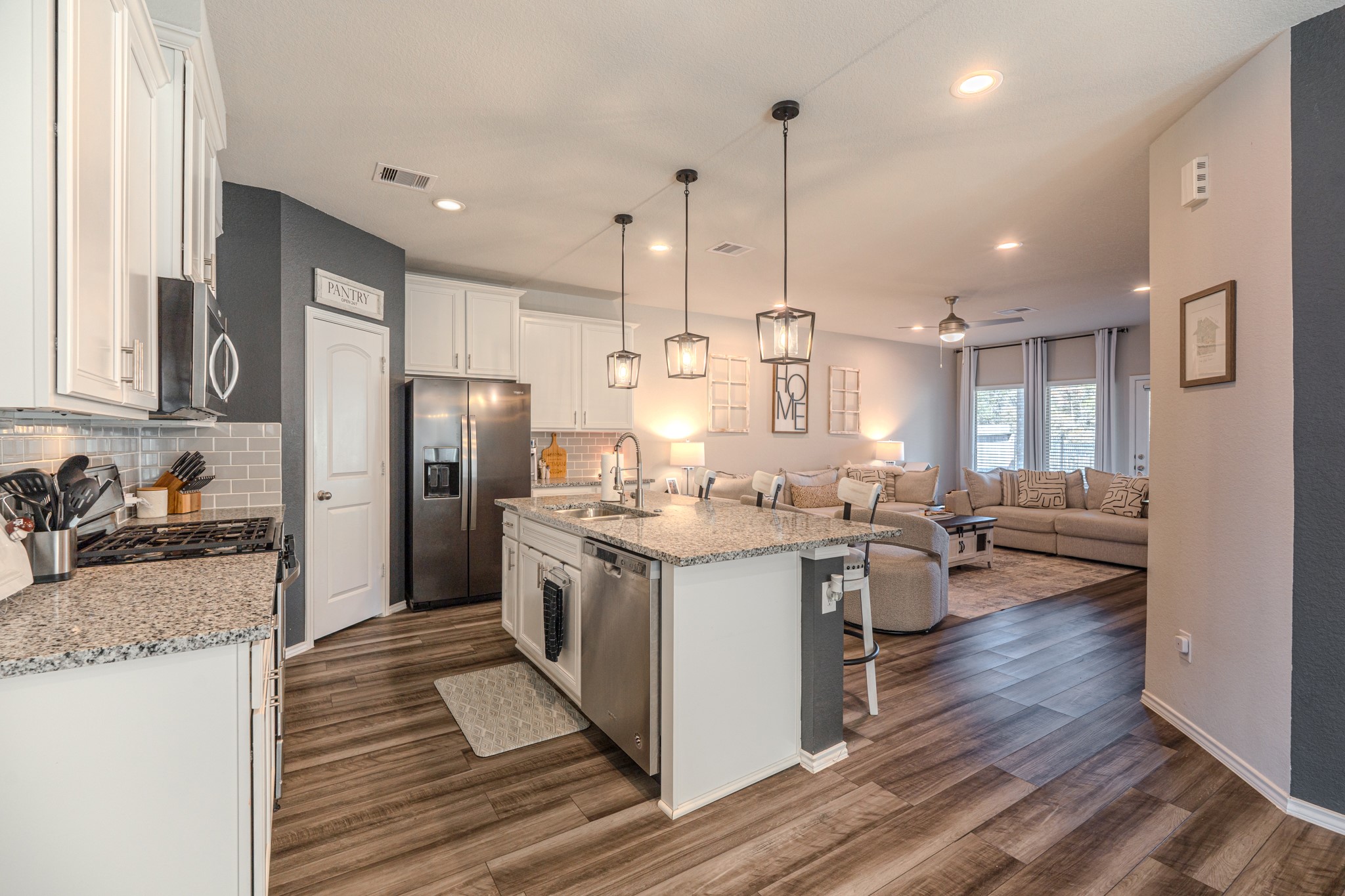 9221 Inland Leather Lane Conroe, TX 77385 - Photo 12 of 47 a kitchen with stainless steel appliances granite countertop a sink stove and refrigerator