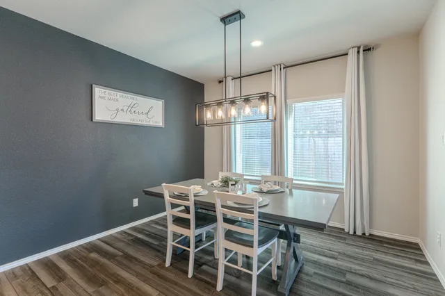 a view of a dining room with furniture window and wooden floor