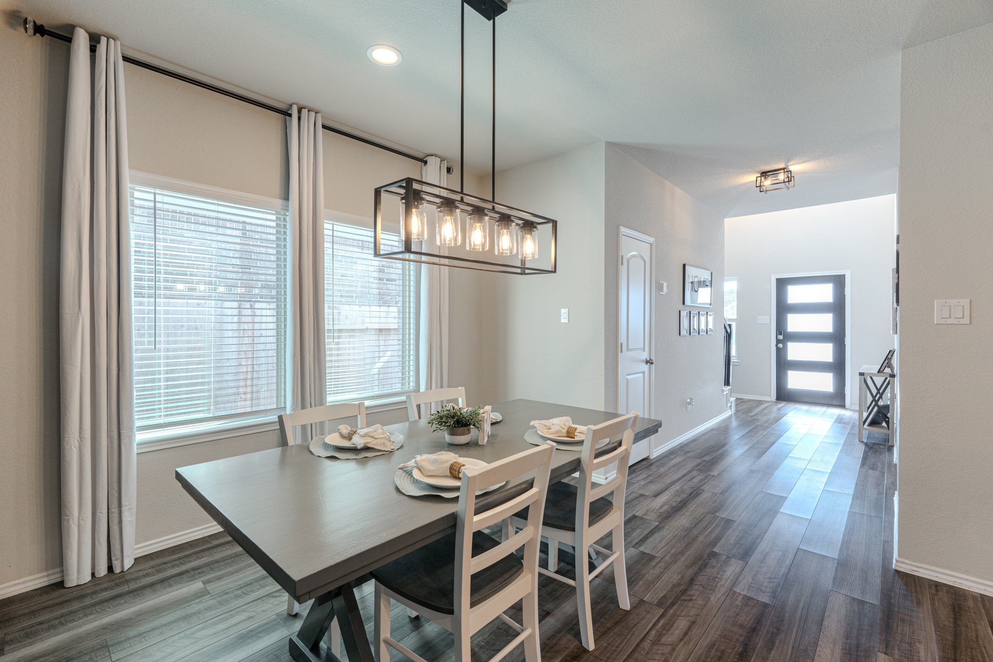 9221 Inland Leather Lane Conroe, TX 77385 - Photo 20 of 47 a view of a dining room with furniture wooden floor and chandelier