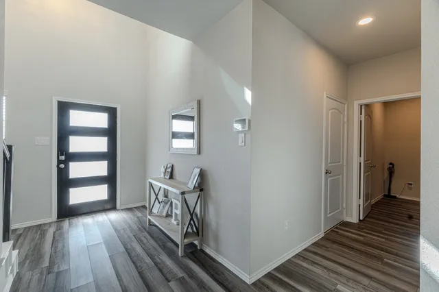a view of a room with wooden floor stairs and a bathroom