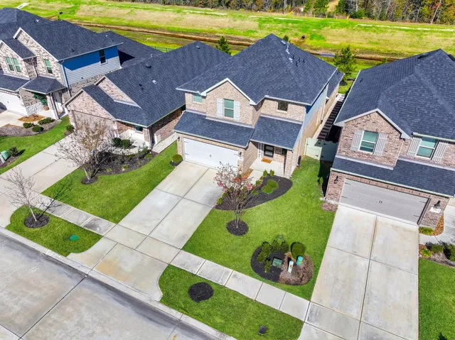 an aerial view of a house with a garden and swimming pool