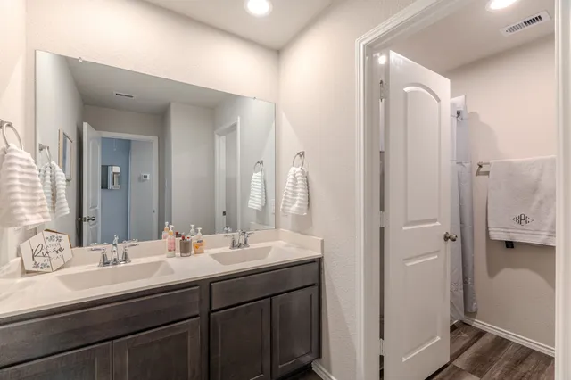 a bathroom with a double vanity sink mirror and double