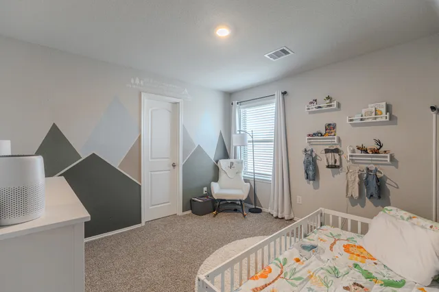 a bedroom with furniture and a wooden floor