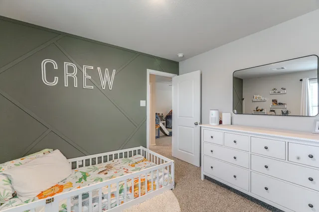 a bedroom with a bed and a dresser in it