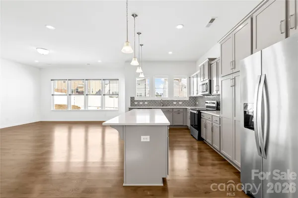 a kitchen with counter top space a sink appliances and cabinets