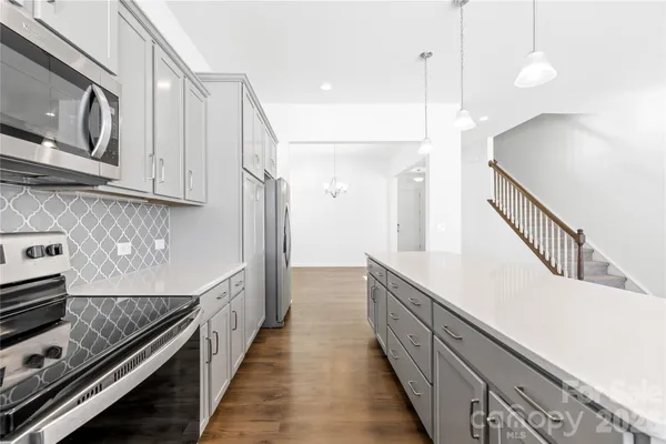 a kitchen with sink a stove and cabinets