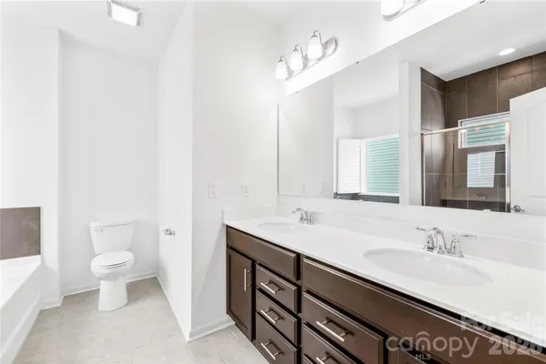 a bathroom with a sink double vanity and a toilet
