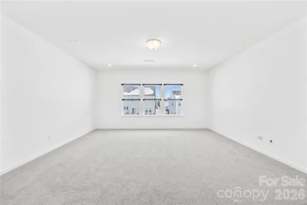 a bedroom with a bed and a potted plant