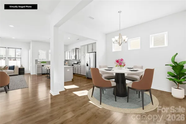 a view of a dining room with furniture and wooden floor