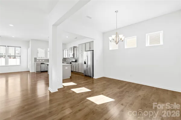 a view of a kitchen with wooden floor and a window