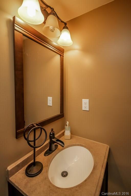 7700 West Berkeley Road Denver, NC 28037 - Photo 17 of 24 a bathroom with a sink and mirror