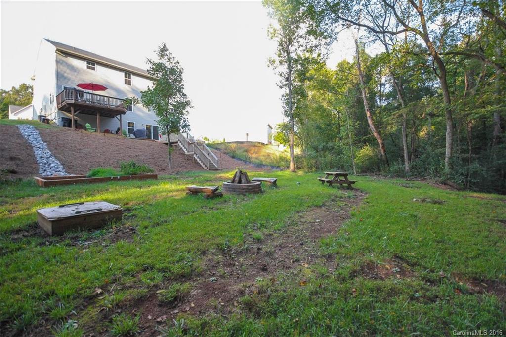 7700 West Berkeley Road Denver, NC 28037 - Photo 22 of 24 a view of a backyard with plants and a park