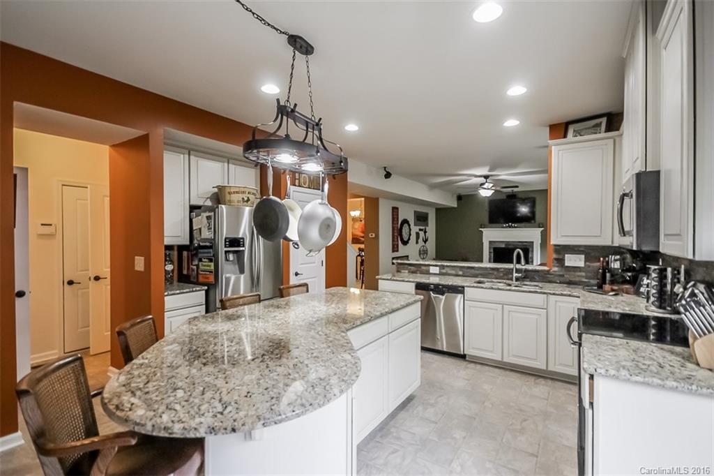 7700 West Berkeley Road Denver, NC 28037 - Photo 4 of 24 a large kitchen with a counter space a sink stainless steel appliances and cabinets