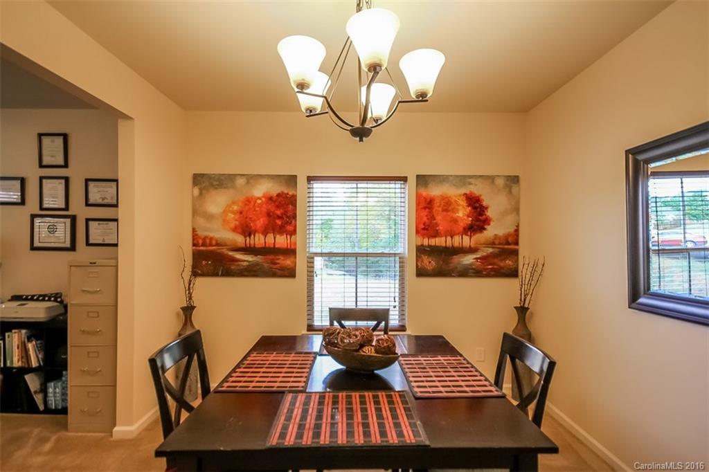 7700 West Berkeley Road Denver, NC 28037 - Photo 6 of 24 a view of a dining room with furniture and chandelier