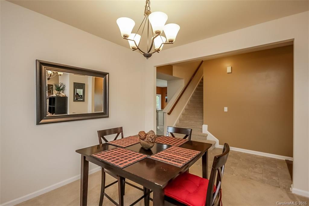 7700 West Berkeley Road Denver, NC 28037 - Photo 7 of 24 a view of a dining room with furniture and chandelier