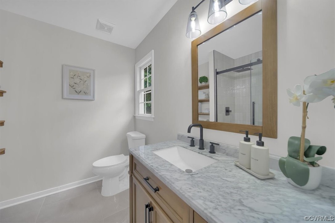 2020 Lone Ridge Drive Powhatan, VA 23139 - Photo 21 of 48 a bathroom with a granite countertop sink a toilet and a mirror