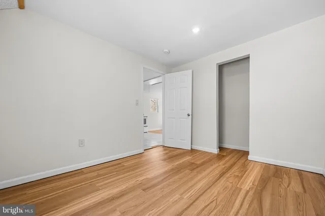 a view of a barn in the backyard with large tree