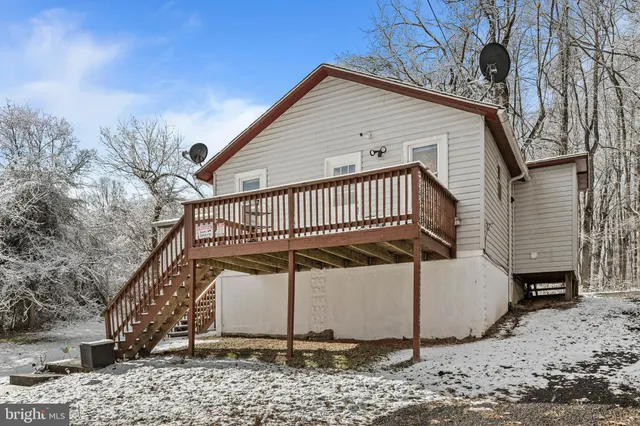 a view of wooden house with a yard