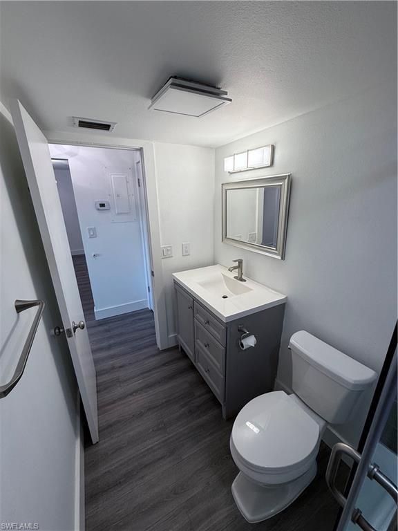 200 Valley Stream Drive, Unit 8B Naples, FL 34113 - Photo 12 of 21 a spacious bathroom with a toilet sink and mirror