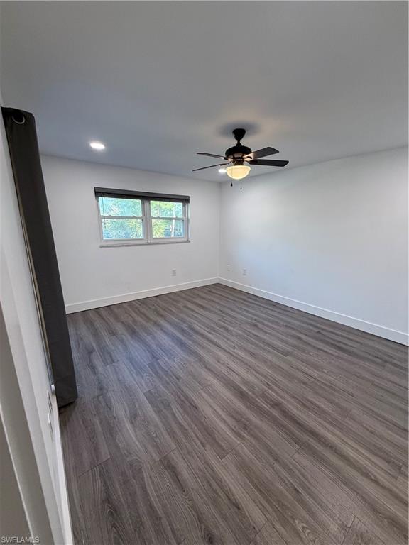 200 Valley Stream Drive, Unit 8B Naples, FL 34113 - Photo 13 of 21 wooden floor in an empty room with a window