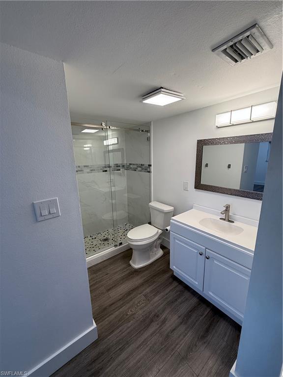 200 Valley Stream Drive, Unit 8B Naples, FL 34113 - Photo 15 of 21 a bathroom with a double vanity sink toilet and shower
