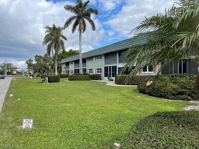 200 Valley Stream Drive, Unit 8B Naples, FL 34113 - Photo 21 of 21 a front view of house with yard and green space