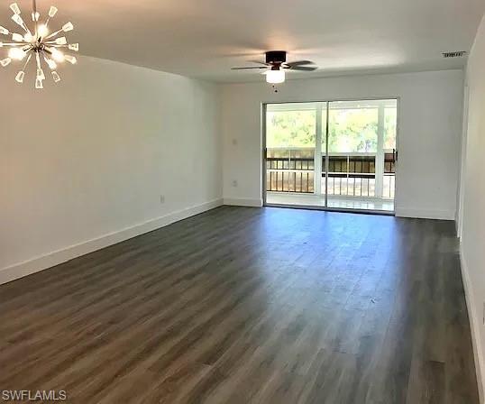 200 Valley Stream Drive, Unit 8B Naples, FL 34113 - Photo 5 of 15 Spacious living area featuring modern wood-look flooring and a contemporary light fixture