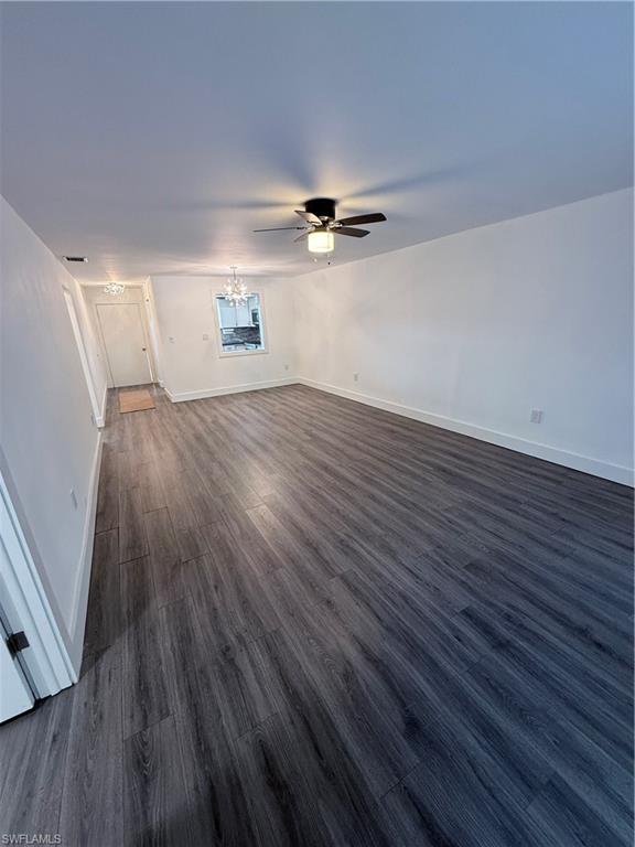 200 Valley Stream Drive, Unit 8B Naples, FL 34113 - Photo 6 of 21 wooden floor in an empty room with a window