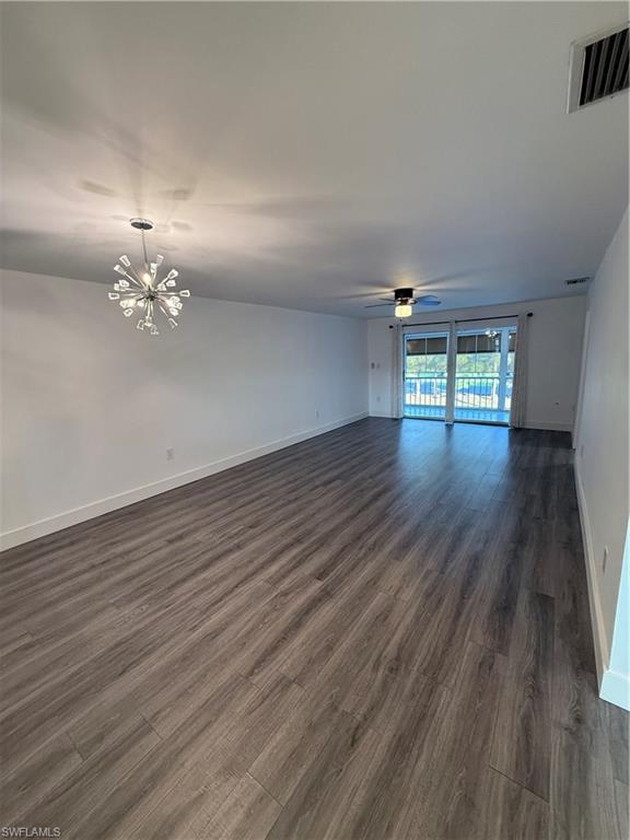 200 Valley Stream Drive, Unit 8B Naples, FL 34113 - Photo 7 of 21 wooden floor in an empty room with a window