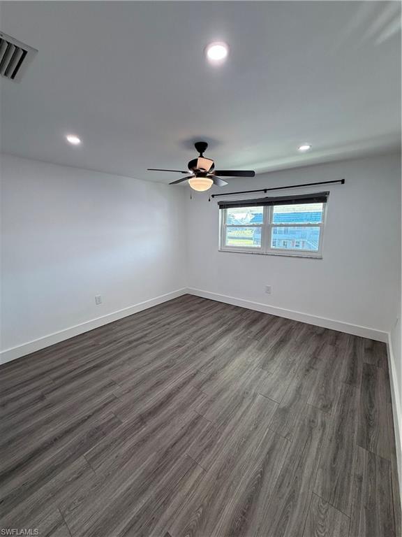 200 Valley Stream Drive, Unit 8B Naples, FL 34113 - Photo 9 of 21 an empty room with wooden floor and windows