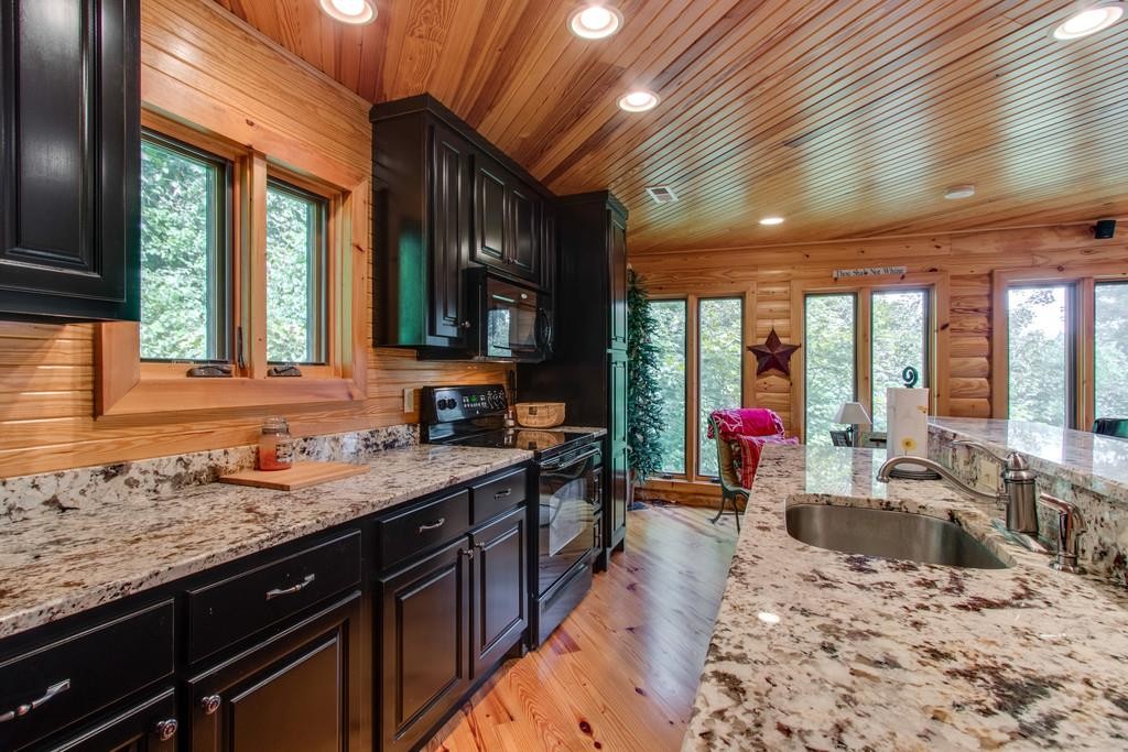 320 Captain Point Silver Point, TN 38582 - Photo 11 of 23 a large kitchen with granite countertop a sink and a counter top space
