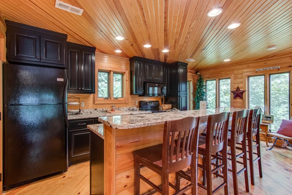 320 Captain Point Silver Point, TN 38582 - Photo 13 of 23 a kitchen with stainless steel appliances granite countertop table chairs and wooden cabinets