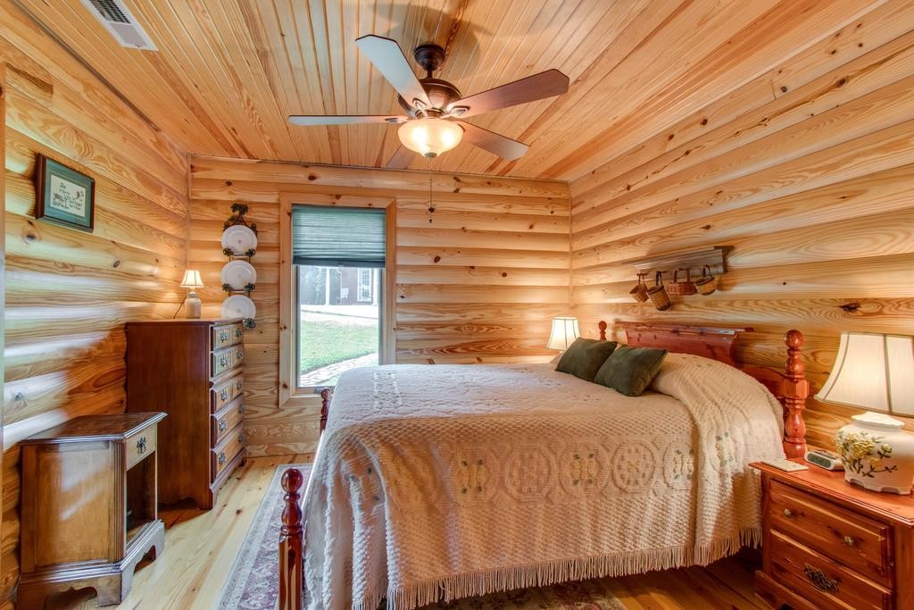 320 Captain Point Silver Point, TN 38582 - Photo 14 of 23 a bedroom with a bed and wooden floor