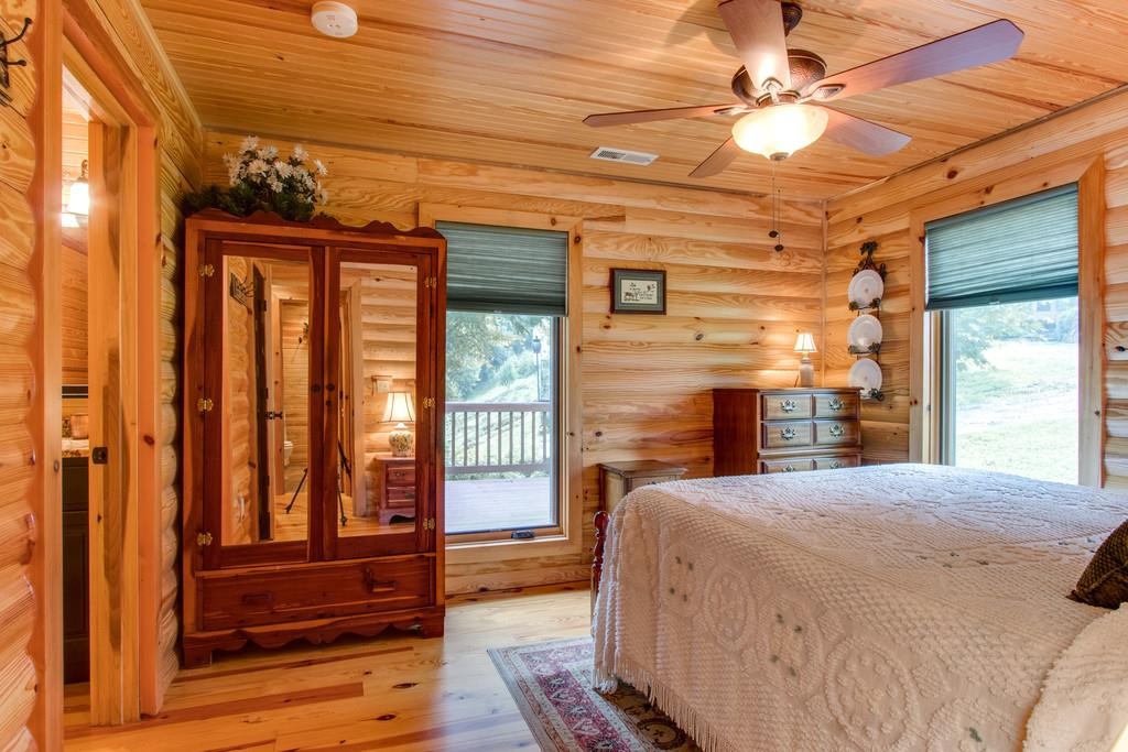 320 Captain Point Silver Point, TN 38582 - Photo 16 of 23 a bedroom with a bed and a large window with wooden floor